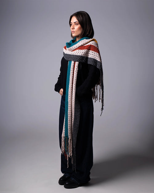 Woman wearing a colorful scarf on a gray background