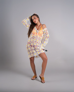 Woman wearing a floral dress on a gray background
