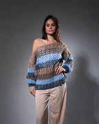 Woman wearing a patterned sweater against a gray background